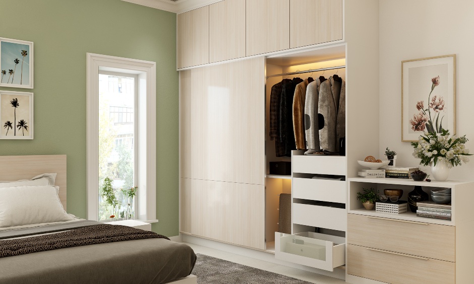 Sleek sliding wardrobe design with light wood laminate finish