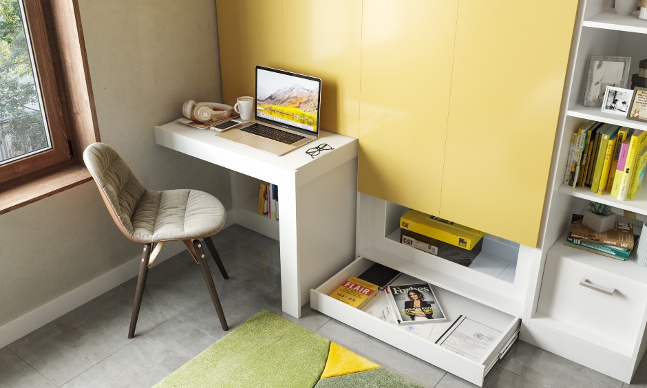 Kids wardrobe design with a pull out study table and skirting drawer to store items