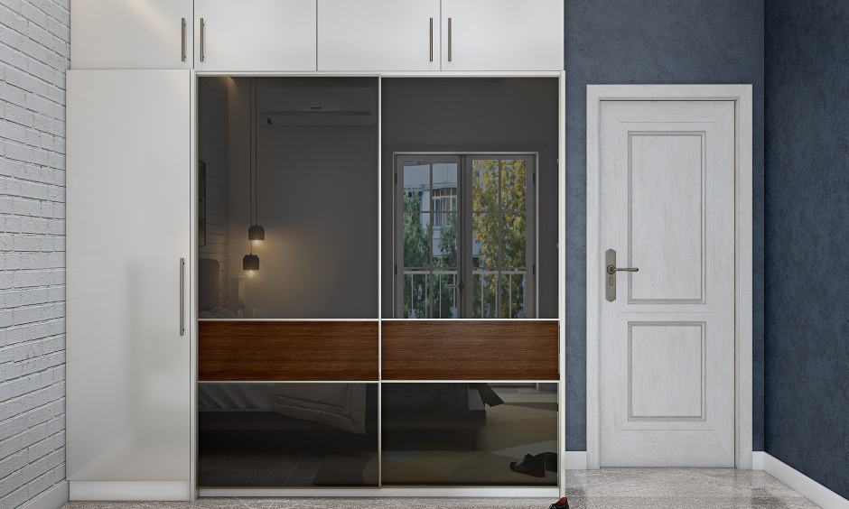 Wardrobe design with sliding doors with tinted glass lend a sleek look