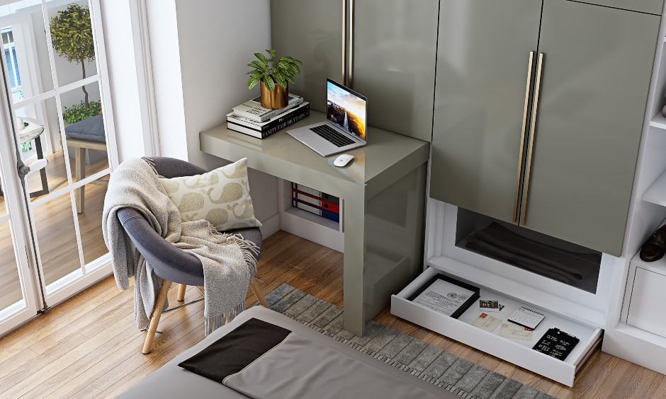 Grey and white wardrobe with space saving pull out study desk and skirting drawer