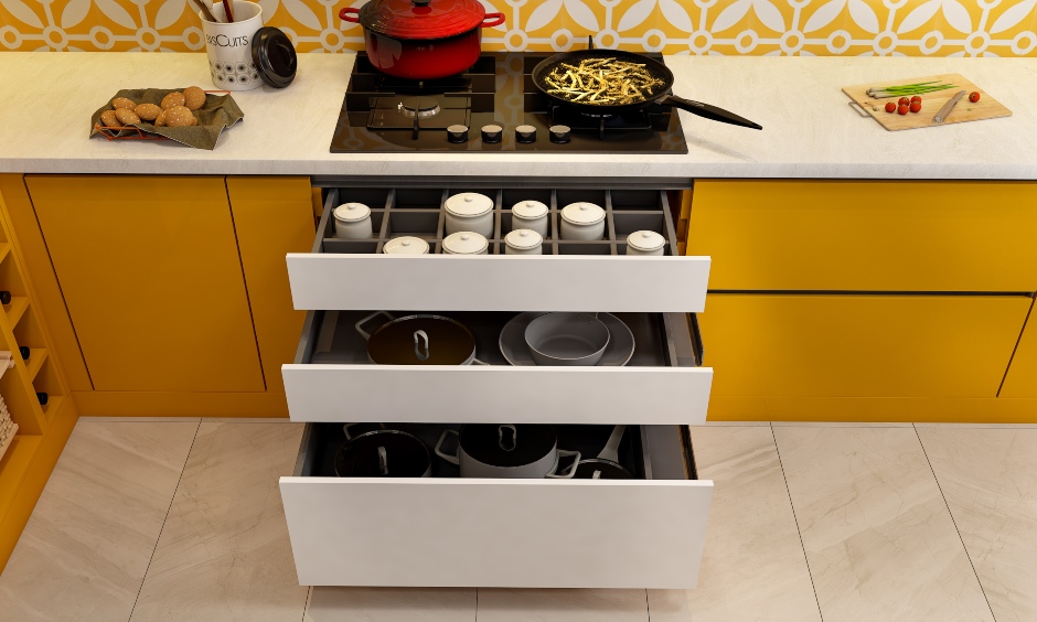 Modular kitchen designed in orange with drawers and inbuilt organizers