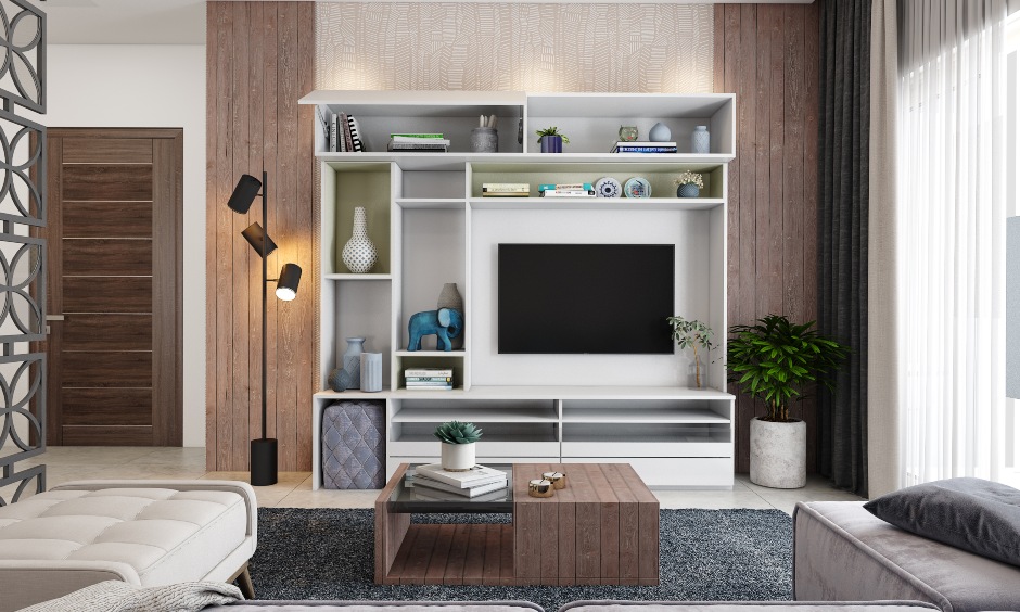 Living room interior design for home where the tv unit is a combination of open and closed shelves to store TV remote, magazines