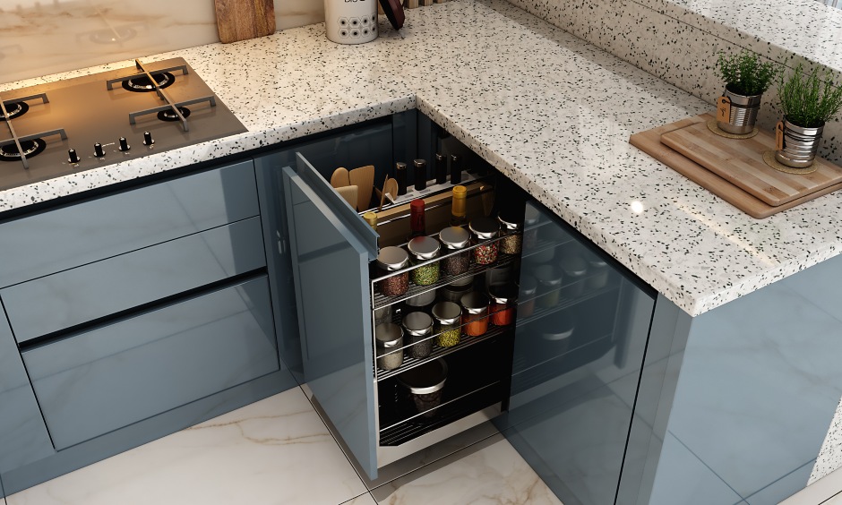 Pull-out base cabinet in modular kitchen interior with handles and magic units to access corner spaces