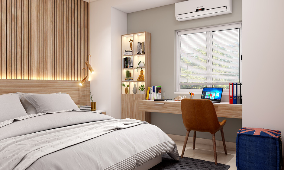 Side View Of A Compact Bedroom With A Study Unit And a Laptop On Table