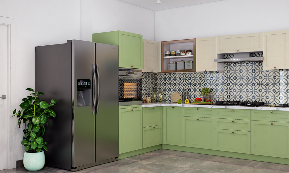 side view of a green color modular kitchen with refrigerator and indoor plant