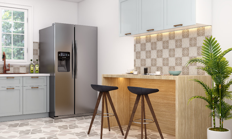A breakfast counter with two stools in small l-shaped kitchen