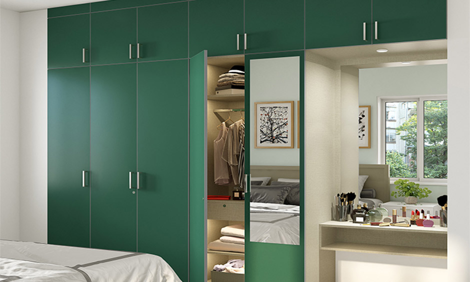 Green wardrobe with attached mirror and functional dressing unit