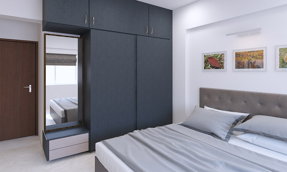 Dark grey cupboard with wall-mounted mirror and dressing drawers