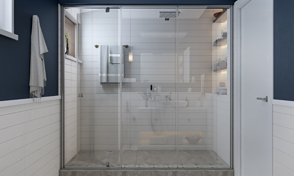 Small bathroom interior with a shower area with glass partition and wall niches.