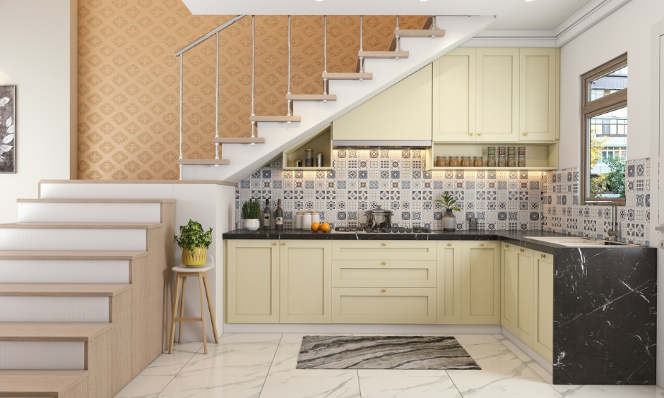 Staircase above modular kitchen showing smart staircase designs for small homes with efficient space planning