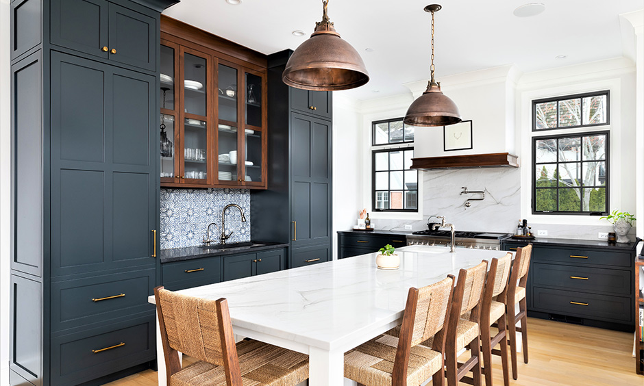 Compact kitchen with blue cabinets and wooden cutlery display combining colour and storage