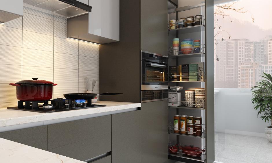 Tall pull-out pantry beside hob and oven designed for narrow kitchen gaps and easy spice storage