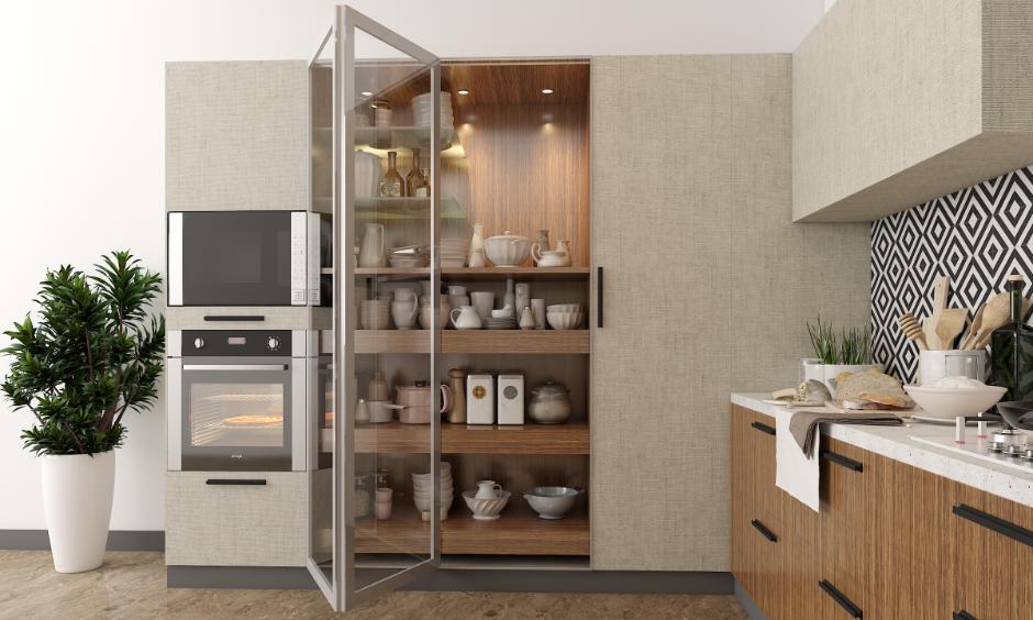 Full-height glass pantry cabinet offering storage and stylish display in matching kitchen tones