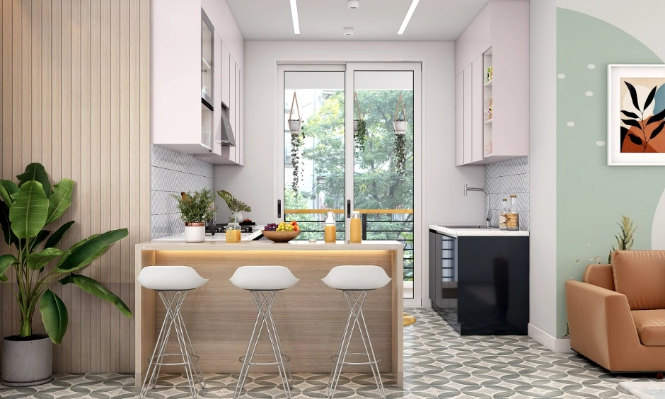 Open-plan kitchen with white cabinetry, a breakfast counter and a dining area visible beyond the workspace. 