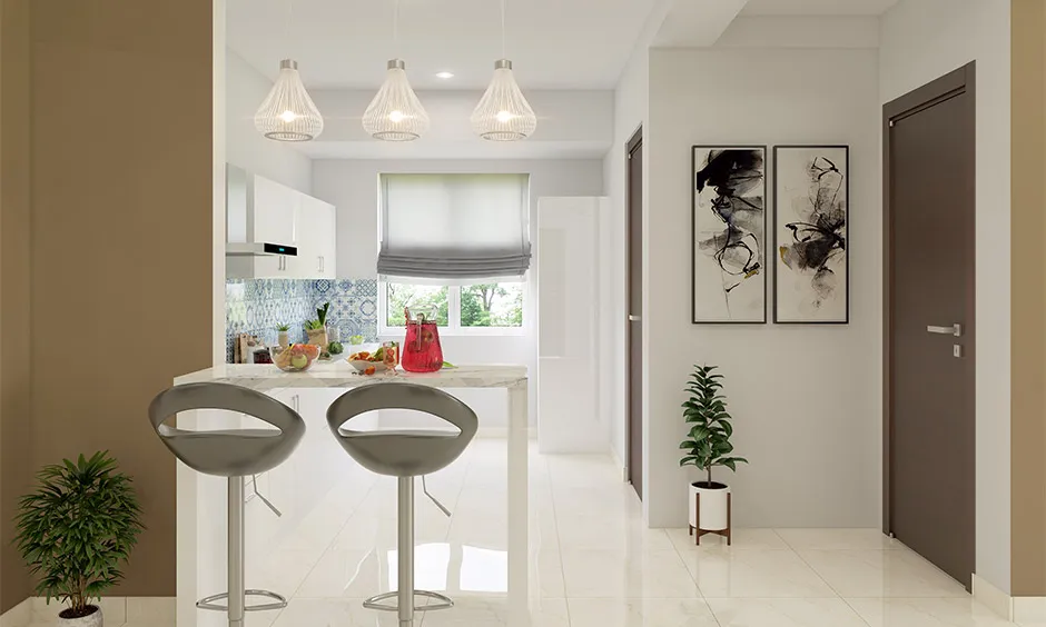 Pendant kitchen lighting adding elegance, symmetry and visual openness to a white kitchen.