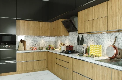 Different types of kitchen countertops, like this speckled stone, suit an L-shaped kitchen with wood-finish cabinets.