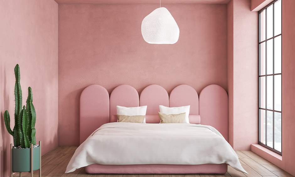 Modern home interior with baby pink walls, warm lighting, and stylish decor for a soft and welcoming look