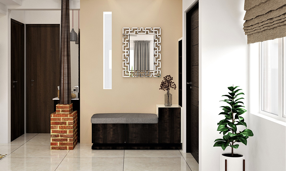 The foyer decor with a mirror and a small cushioned seating area beside the door for a luxe look