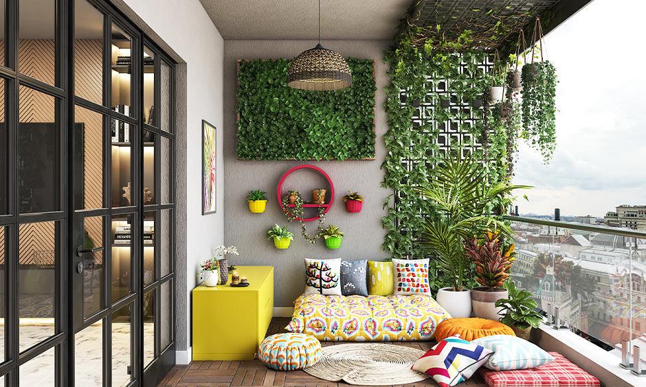 A green velvet sectional, gold lamps, and indoor palms create elegant green interior design ideas in a bright living room.