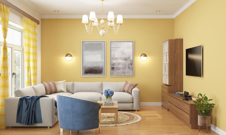 Living room with yellow walls, neutral sofa and soft blue chair in a calming colour palette