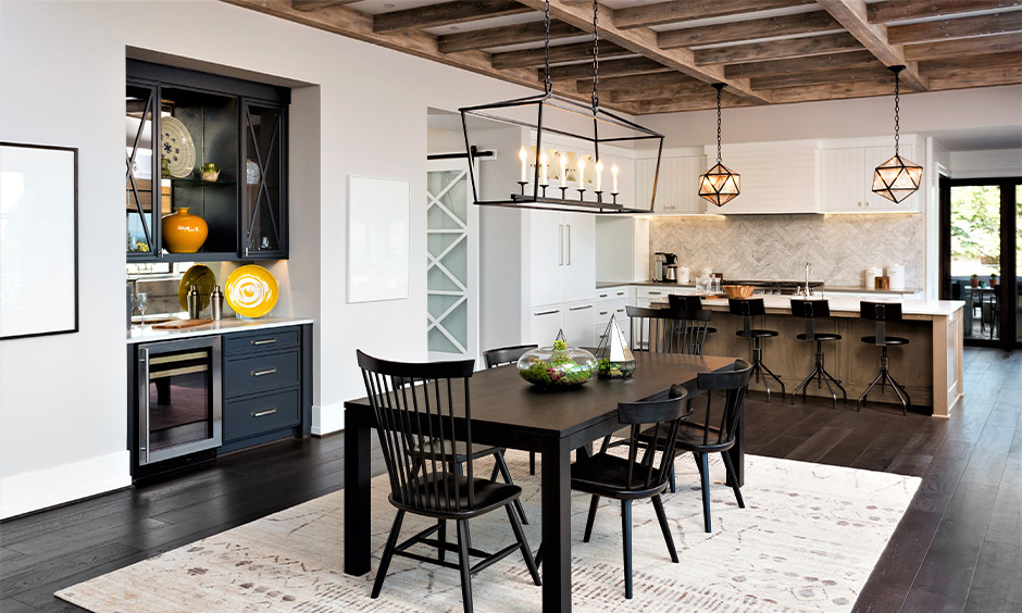 Cosy rustic kitchen with wooden beams, shaker cabinets, and farmhouse sink.