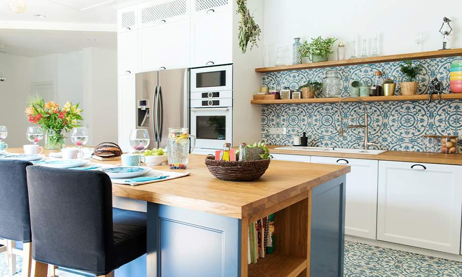 Rustic kitchen with tiled niches, warm wood tones, and wrought-iron lighting.