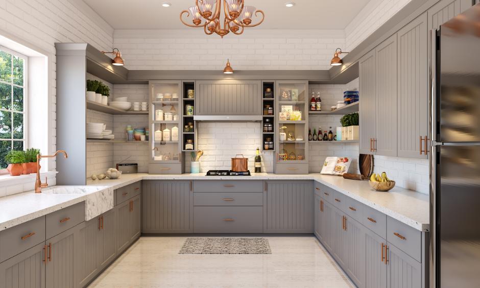 Grey rustic kitchen lit by cane pendant lights and antique bulbs.