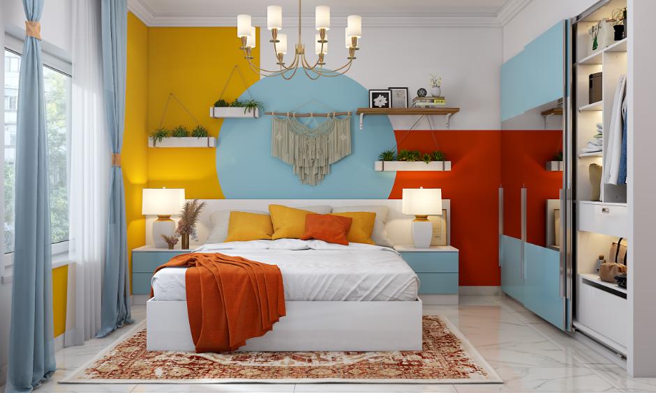 Bedroom featuring a multi colour wall design with blue circle, yellow and orange accents