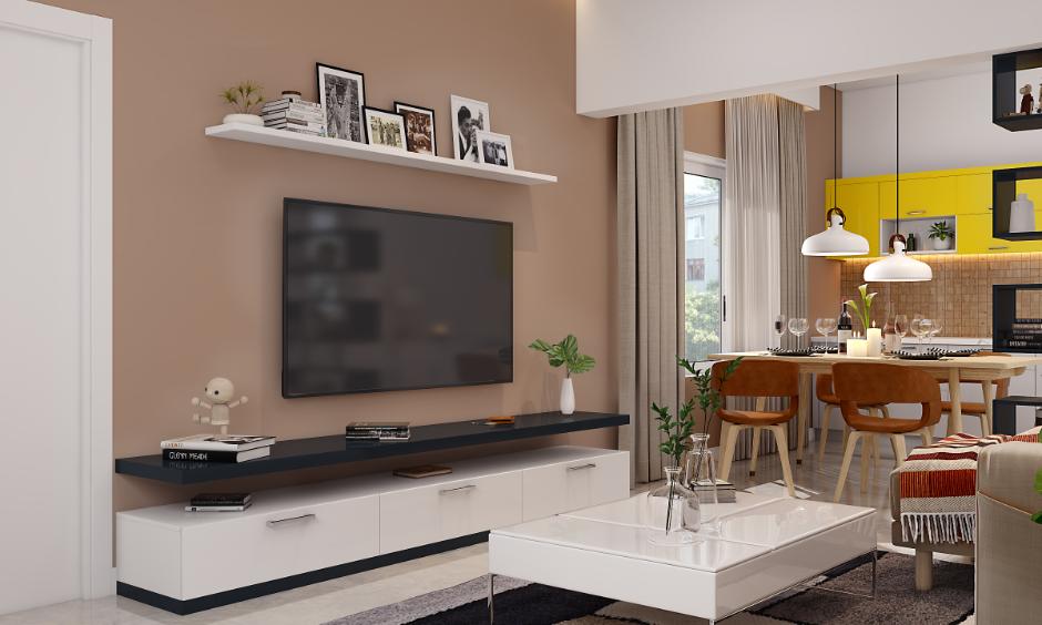 Living room with warm brown wall colour design, white TV unit and soft beige curtains