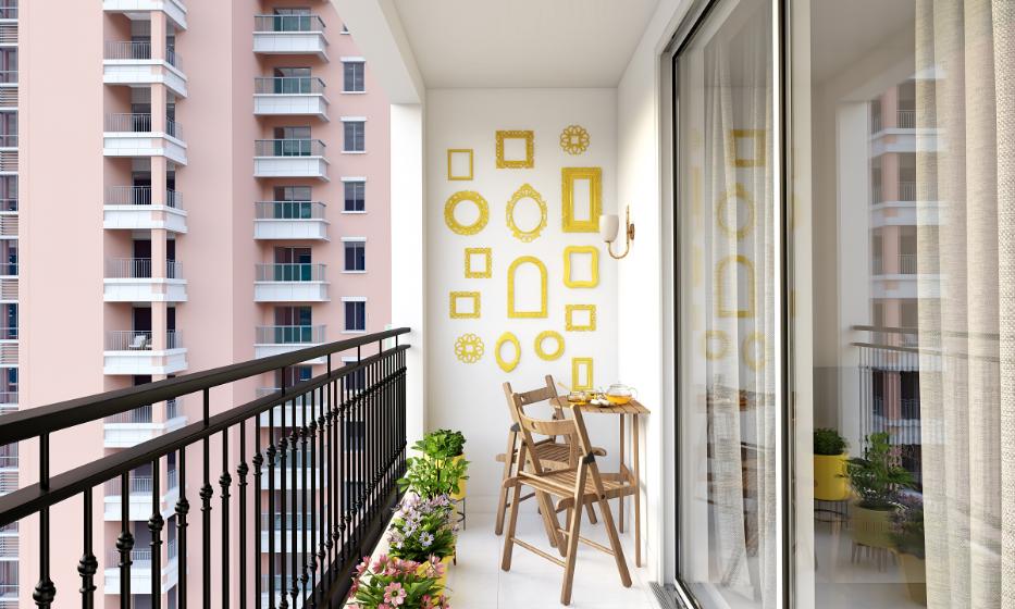 Balcony with black iron railing, wooden chairs and potted plants in a high-rise setting
