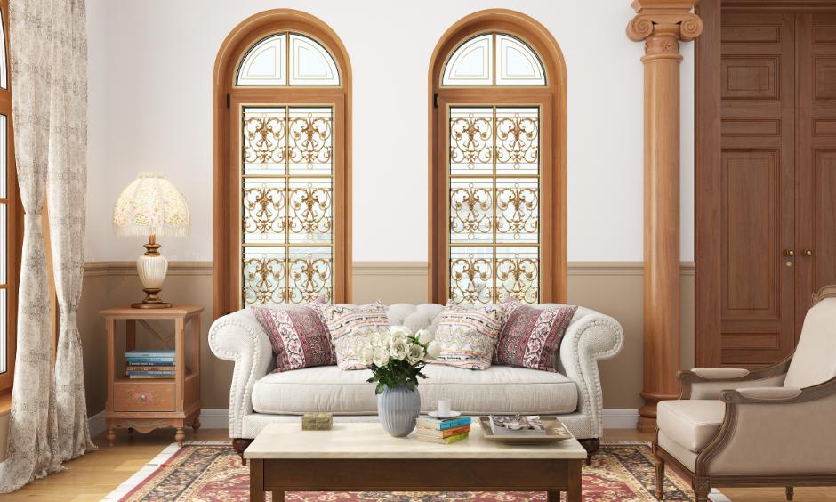 Elegant living room with gold grill paint colour and matching traditional interior design.