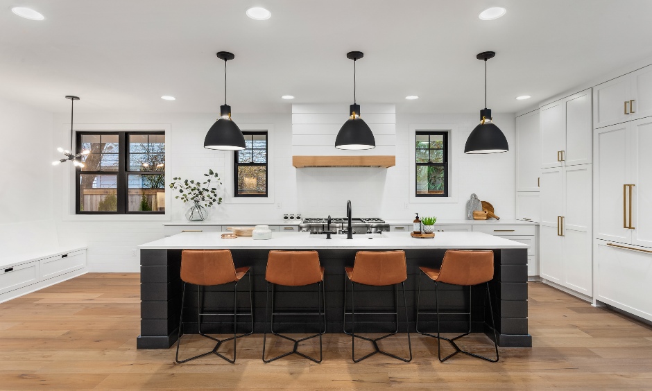 Farmhouse kitchen with exposed beams, beige cabinetry, and an apron sink exudes cosy charm.
