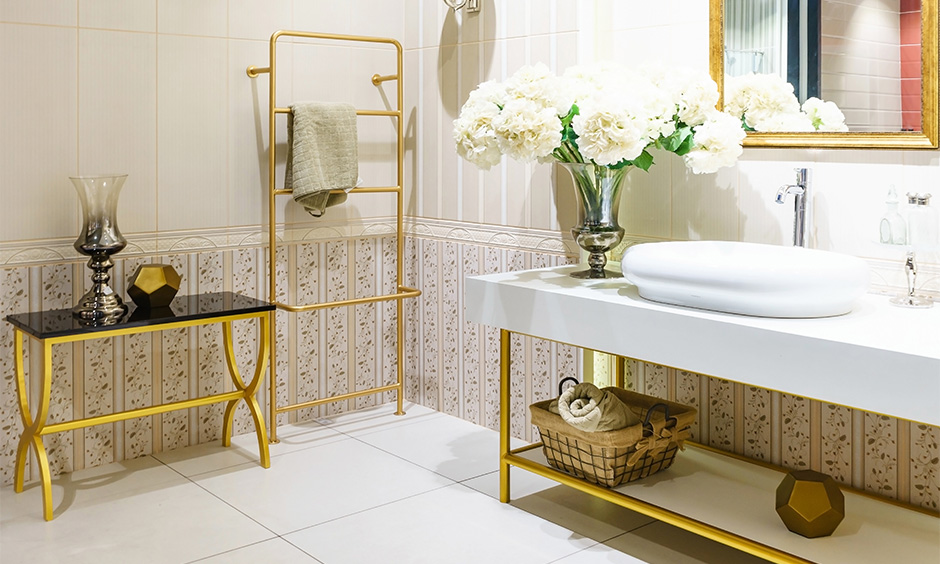 Moroccan bathroom design with golden fixtures, arched mirror, and antique metallic accents.