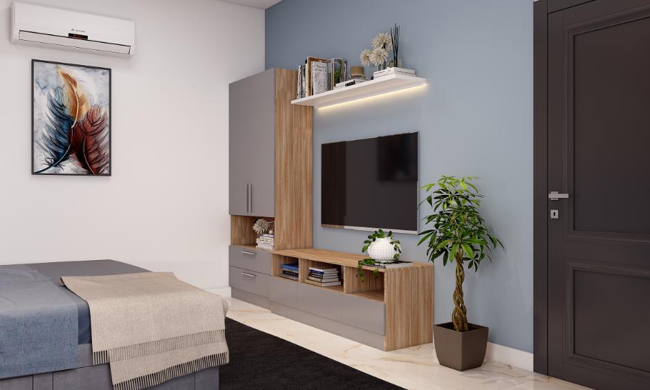 Bedroom TV unit with grey and wood finish made using HDHMR sheet, showing clever material use in home interiors
