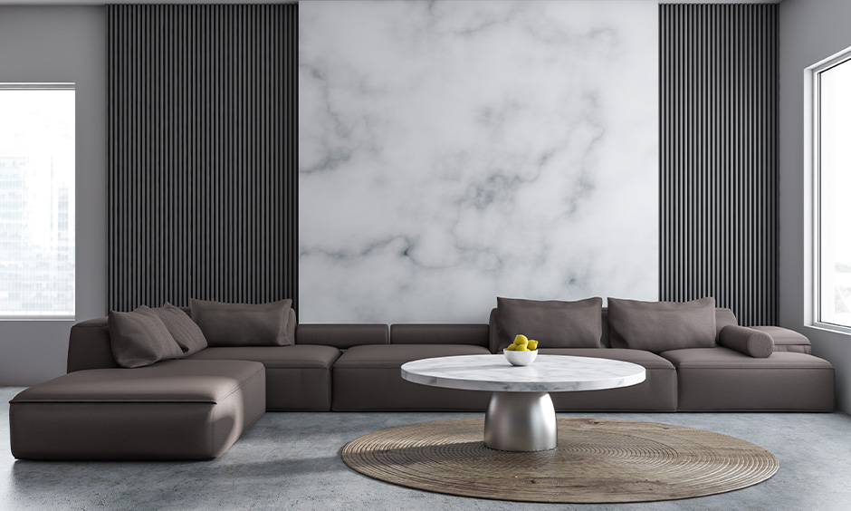 Italian living room design with linen sofa, marble table, muted tones, and statement artwork.