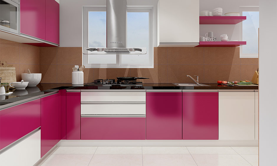 Modern minimalist apartment kitchen with black granite countertops and colourful handleless cabinets.