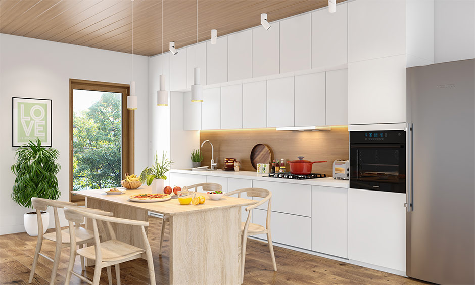 Bright mid-century modern minimalist kitchen with white cabinets and a light wood island.