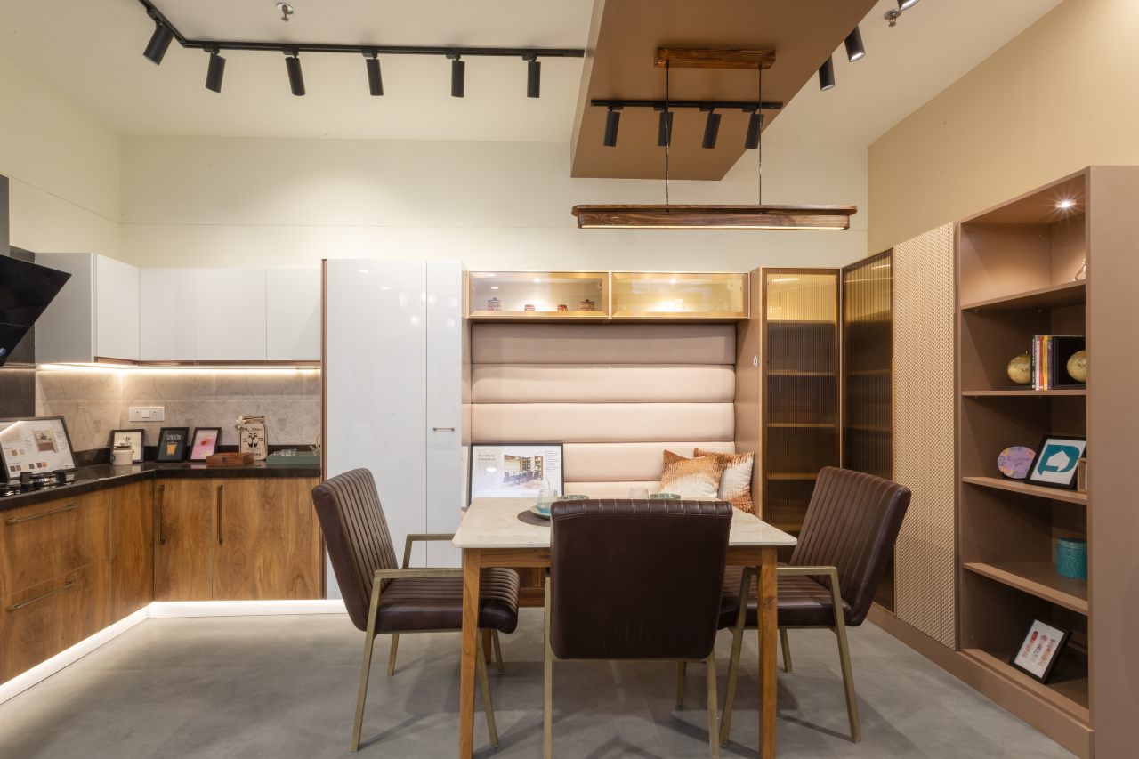 Modern open kitchen with dining table design by Ahmedabad designer, perfect for gatherings.