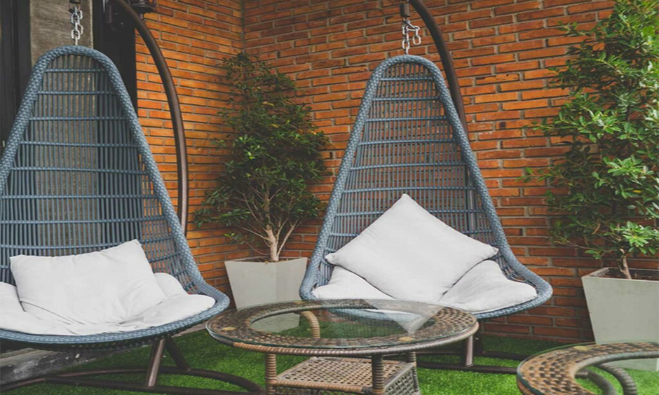 Wooden balcony swing which exudes rustic cafe vibes