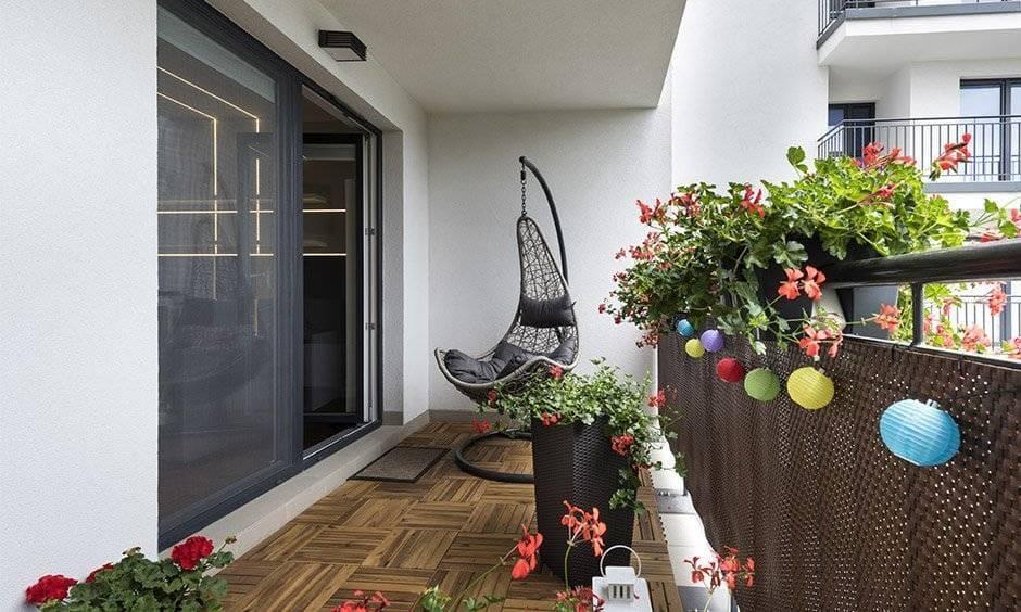 Iron balcony swing paired with wooden flooring perfect for lounging