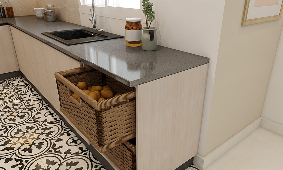 Grey quartz kitchen platform with polished surface, wicker storage baskets, and patterned floor tiles.