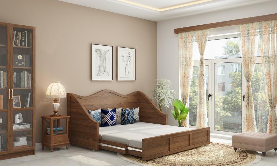 Delhi bedroom with a multifunctional wooden daybed, compact storage, and natural light reflecting smart home design trends.