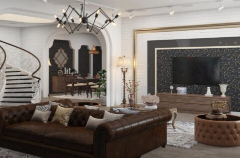 Luxurious Delhi living room with Chesterfield sofa, ornate staircase, and modern-traditional decor reflecting 2025 design trends