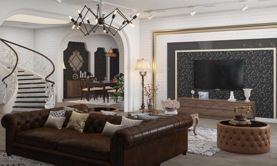Luxurious Delhi living room with Chesterfield sofa, ornate staircase, and modern-traditional decor reflecting 2025 design trends