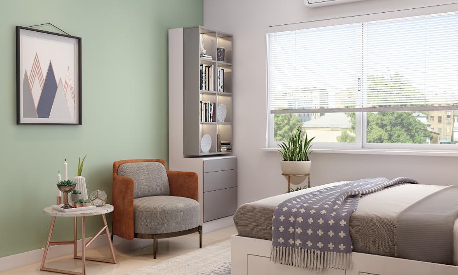 Bedroom interior with pastel green acrylic paint for walls, styled with cosy furniture and natural light.