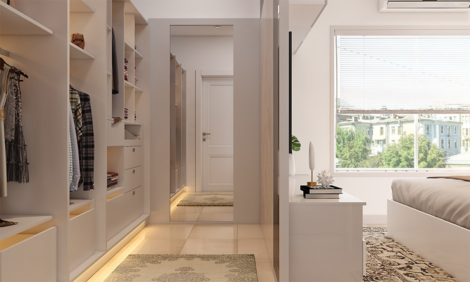 Luxury walk-in closet design with organised shelving, pull-out drawers, and mirror for efficient storage