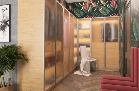 Modern luxury walk-in closet design with glass wardrobes, wooden flooring, and elegant seating