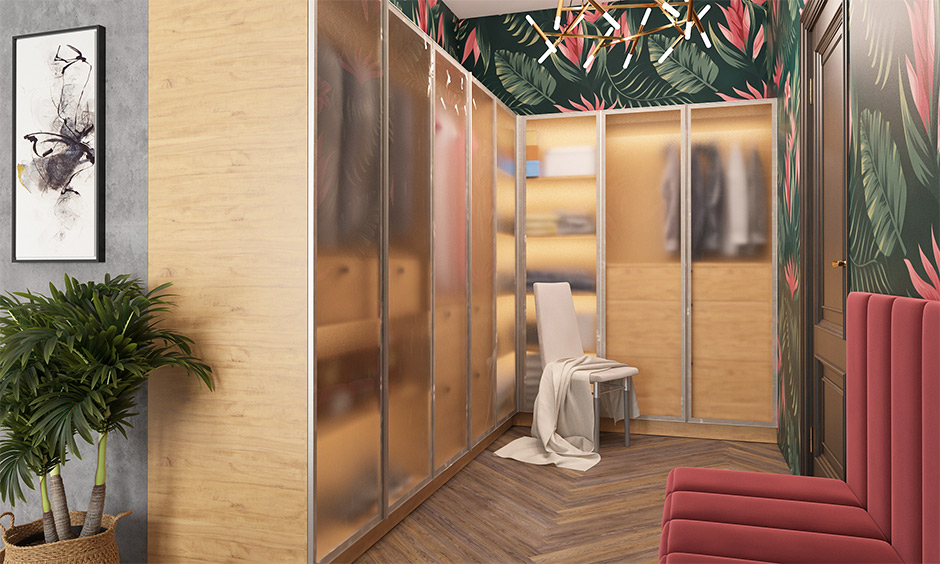 Modern luxury walk-in closet design with glass wardrobes, wooden flooring, and elegant seating