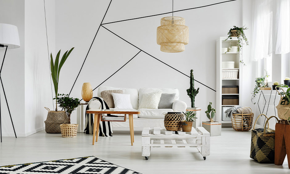 Scandinavian living room with a white wall featuring bold black lines created using tape and paint.