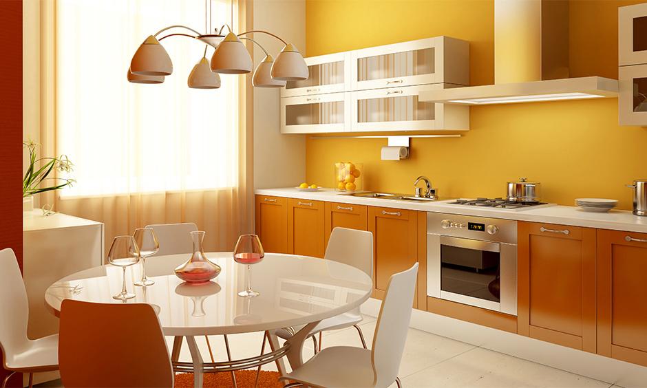 Monochromatic colour scheme interior design with layered yellow and orange kitchen tones.